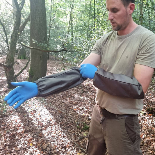 Green gauntlets or sleeve protectors offering full, easy-to-clean protection for dressing game