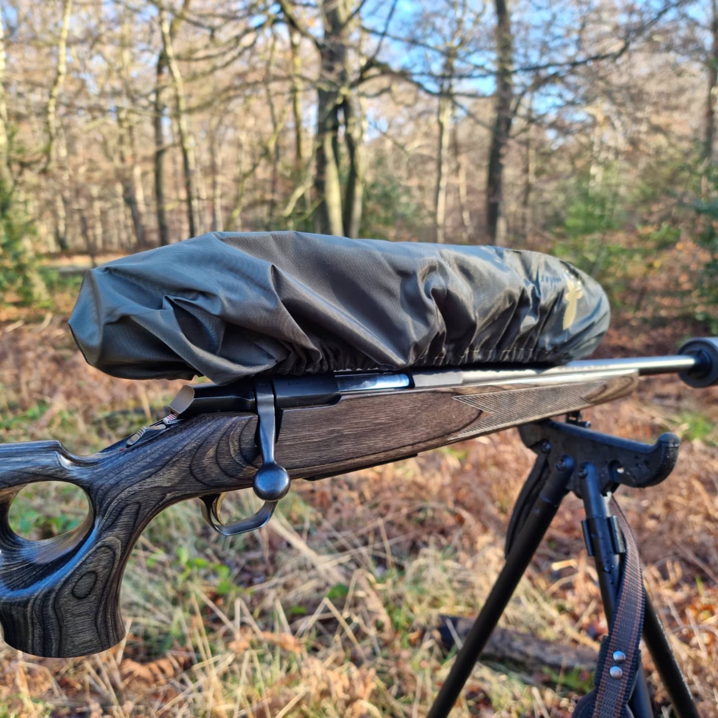 Lightweight, water-resistant slip-on rifle scope cover, designed for quick protection during light rain showers, with a loose fit to accommodate IR or scope accessories